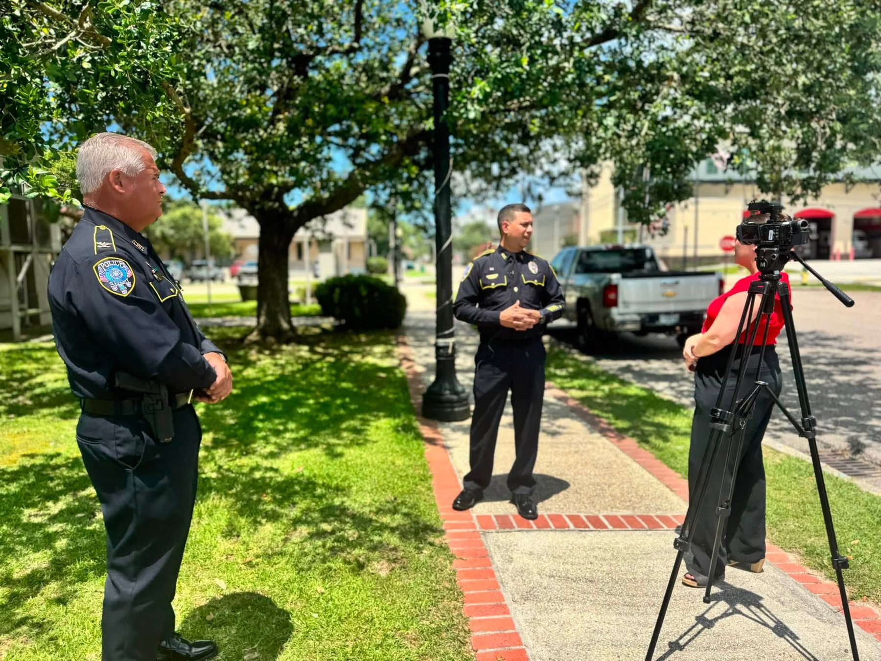 Daniel Seuzeneau taking questions from a local TV reporter on a Slidell sidewalk